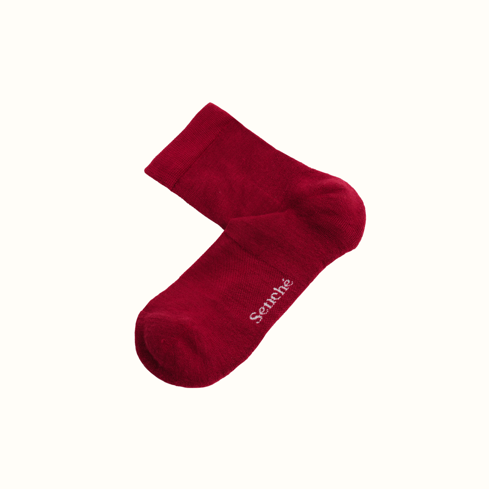 Red sock with 'Senche' branding on a white background