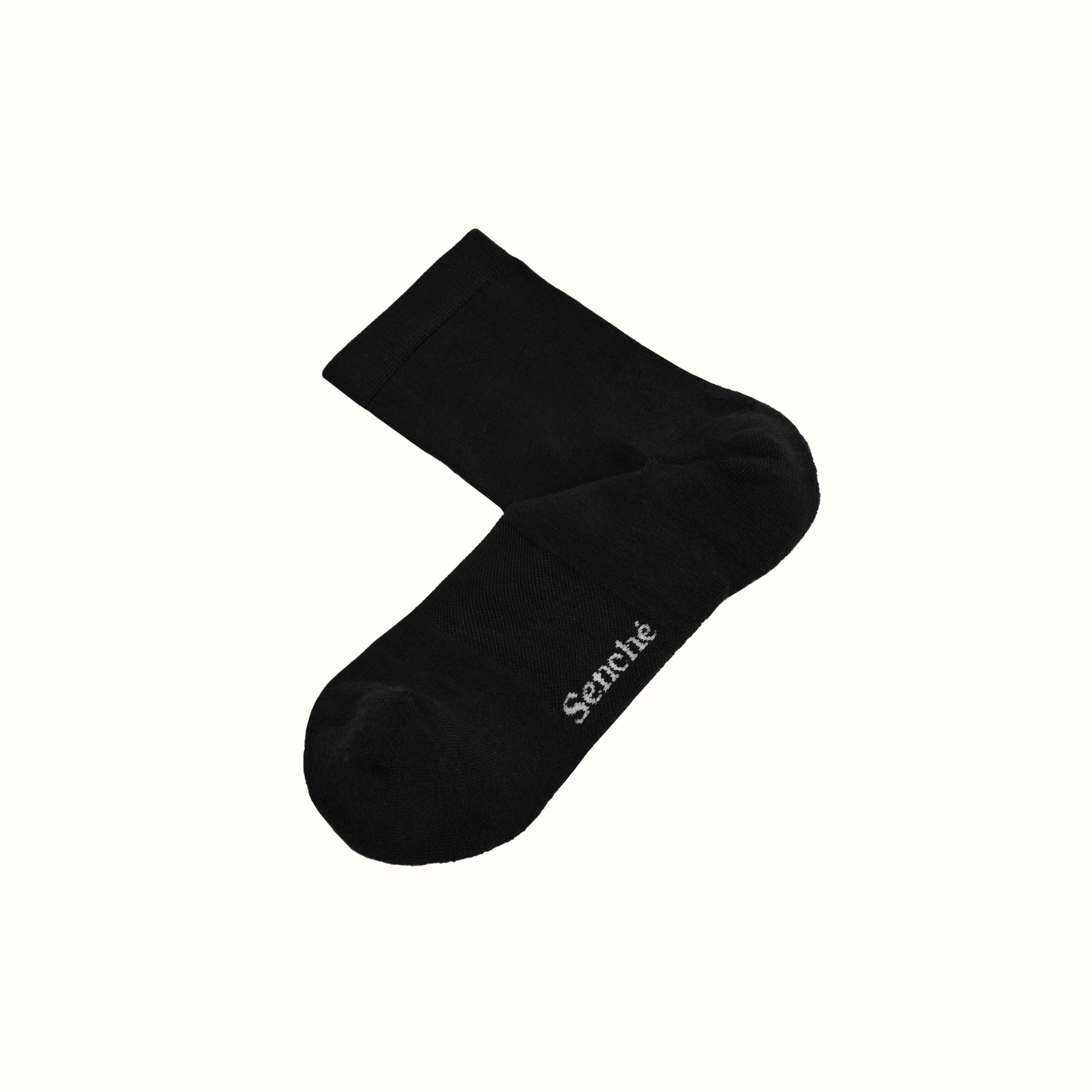 Black sock with 'Senche' branding on a white background